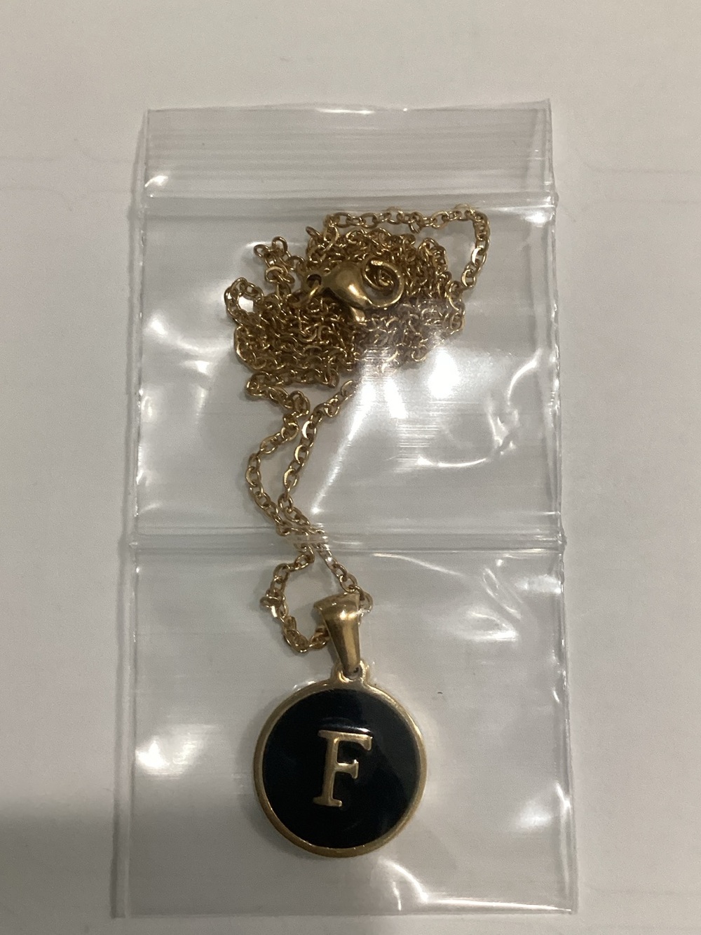 Gold Pendant Necklace with Black Initial F Disc